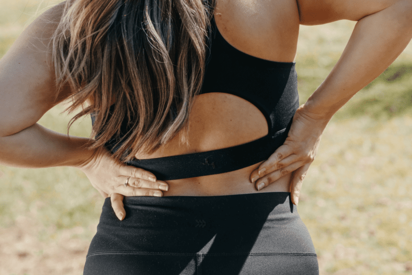 woman-in-workout-clothes-with-back-pain